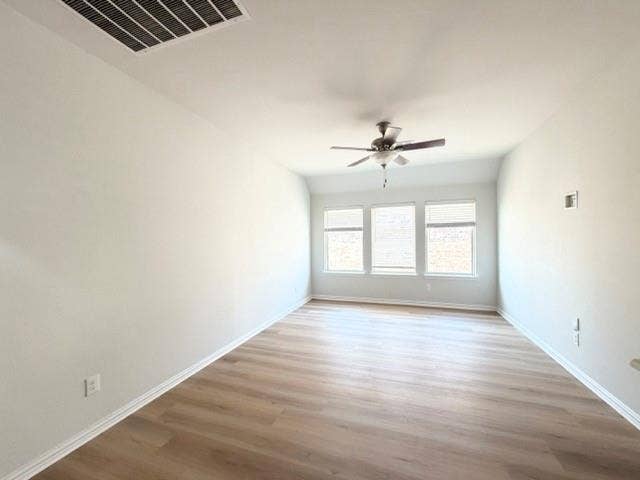 5609 Meritage Street, McKinney, TX 75070 Wood-finish flooring, multiple windows with blinds, ceiling fan, and white walls
