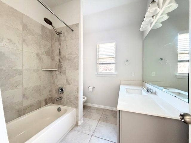 5609 Meritage Street, McKinney, TX 75070 Bathtub with tile surround, shower fixture with handheld spray, single vanity with integrated sink, expansive mirror, and window with blinds