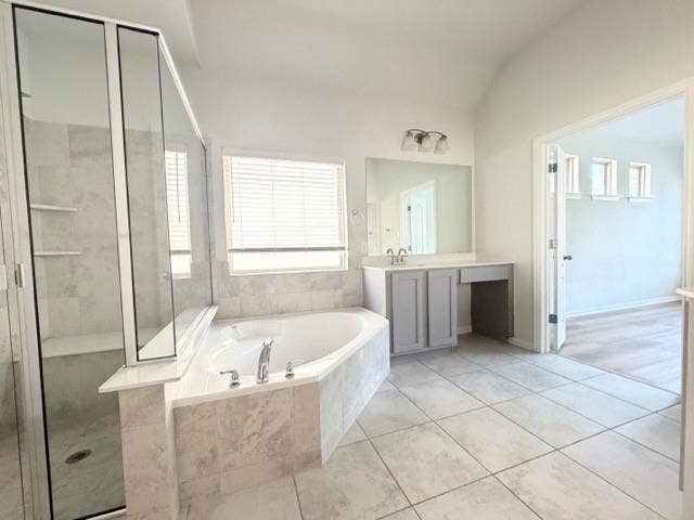 5609 Meritage Street, McKinney, TX 75070 Corner soaking tub, separate glass-enclosed shower, dual vanity, tile flooring, and vaulted ceiling