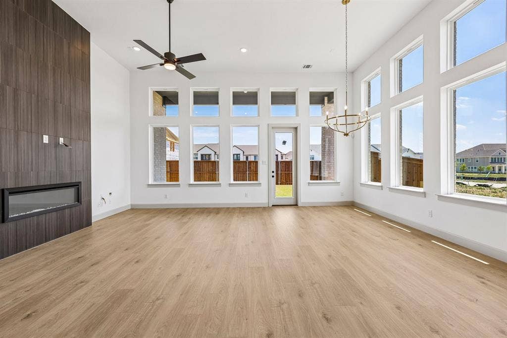 15828 Amber Street, Frisco, TX 75033 Featuring walls of windows and a stunning floor to ceiling fireplace, friends and family will love gathering in your new dream home!