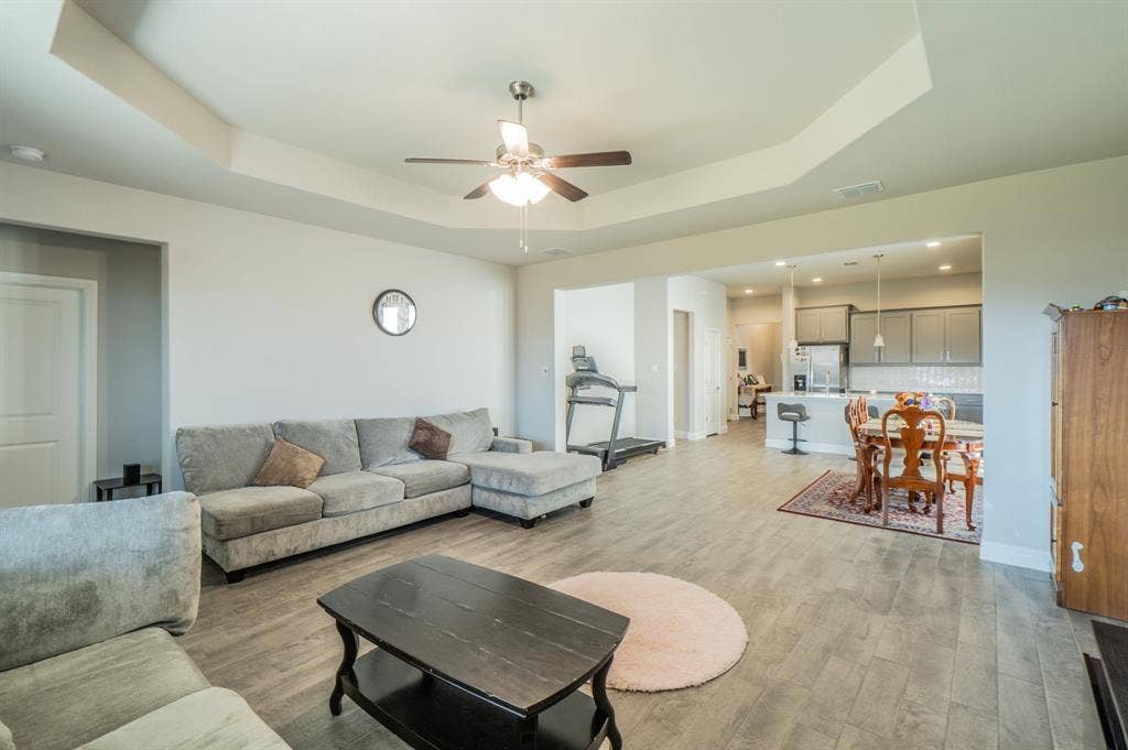 2041 St Andrews Way, Argyle, TX 76226 Tray ceiling with a ceiling fan, wood-finish flooring, and recessed lighting