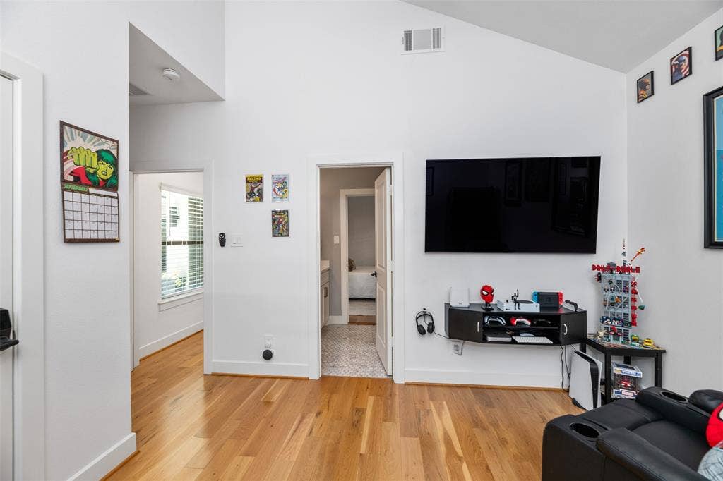3rd bedroom, Vaulted ceiling, recessed lighting, wood-finish flooring, white walls, and white trim