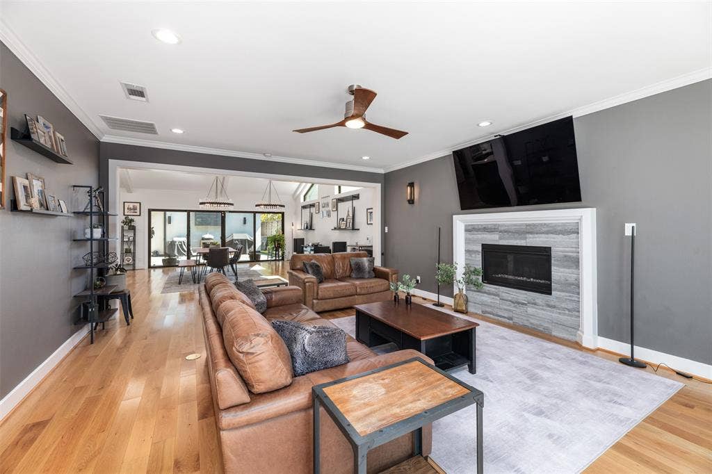 Hardwood flooring, recessed lighting, and a ceiling fan with wood-finish blades