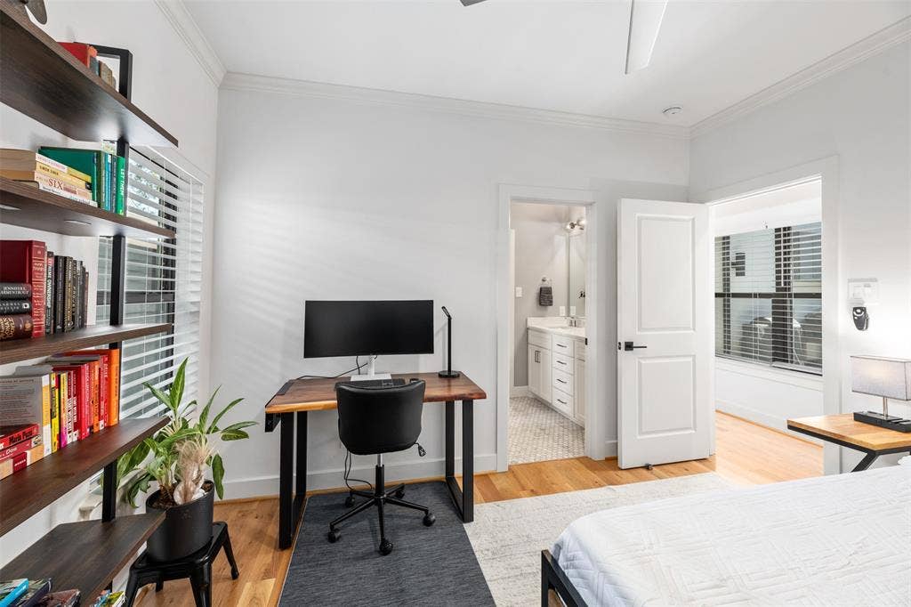 2nd bedroom, Hardwood flooring, crown molding, built-in shelving, white paneled doors, and a ceiling fan
