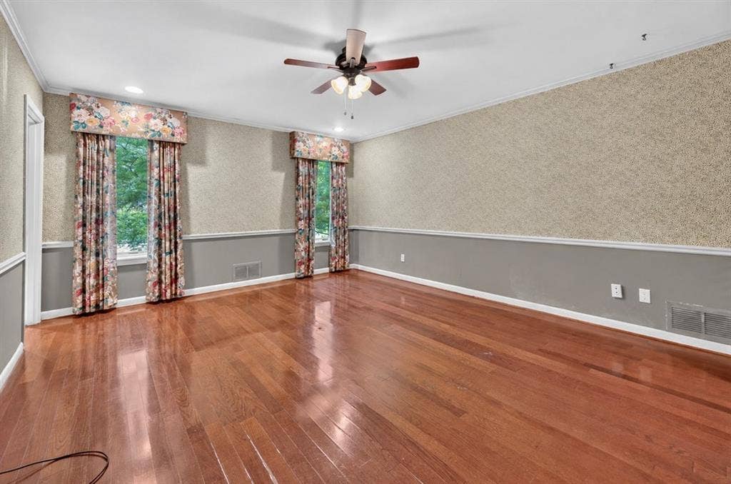 702 Mulberry Drive, Athens, TX 75751 Hardwood flooring, crown molding, chair rail, and ceiling fan with light fixture