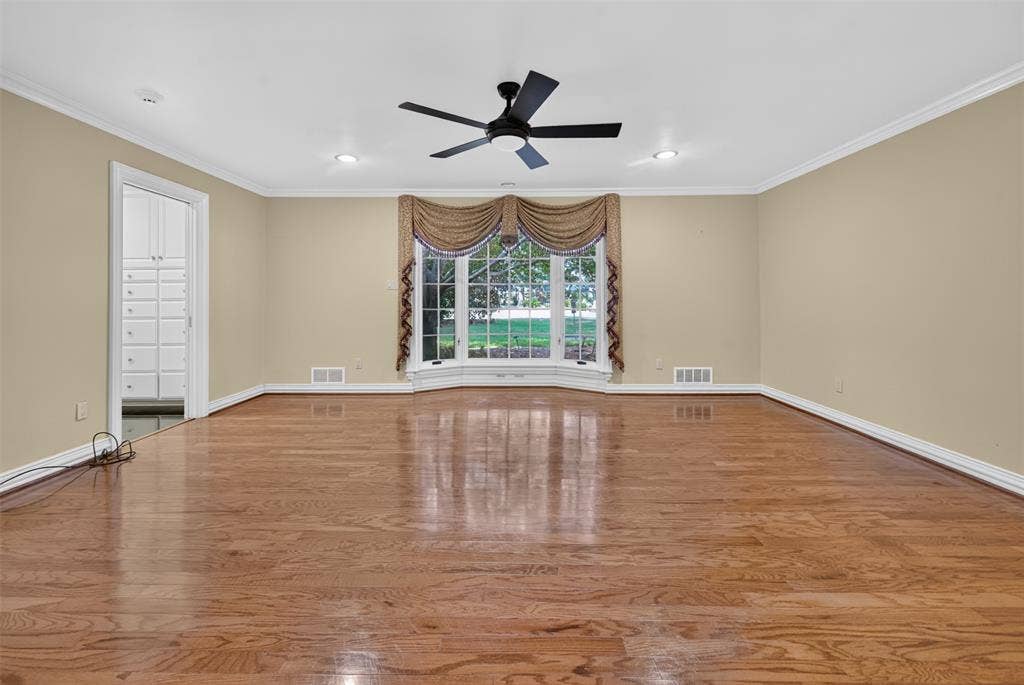 702 Mulberry Drive, Athens, TX 75751 Hardwood flooring, bay window, recessed lighting, ceiling fan, and built-in cabinetry