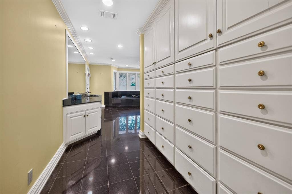 702 Mulberry Drive, Athens, TX 75751 Extensive built-in cabinetry with brass hardware, tile flooring, recessed lighting, and crown molding