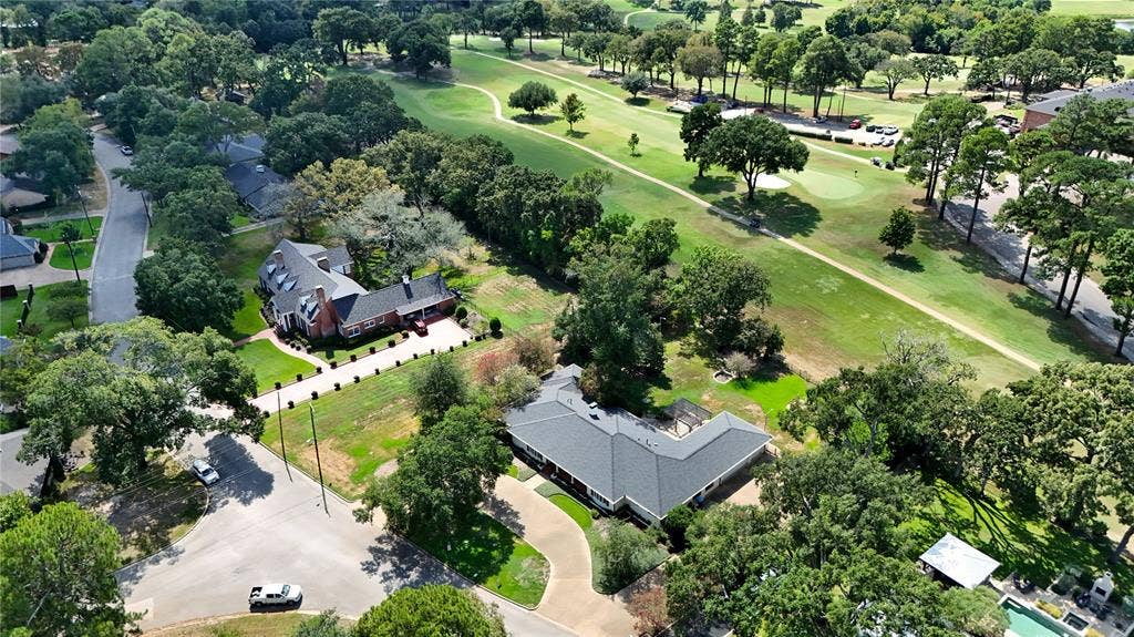 702 Mulberry Drive, Athens, TX 75751 Property featuring a brick exterior, extensive green space, mature trees, and a paved driveway