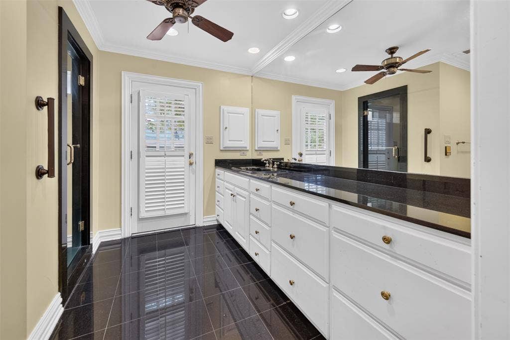 702 Mulberry Drive, Athens, TX 75751 White cabinetry with gold-tone hardware, granite countertop, and granite flooring