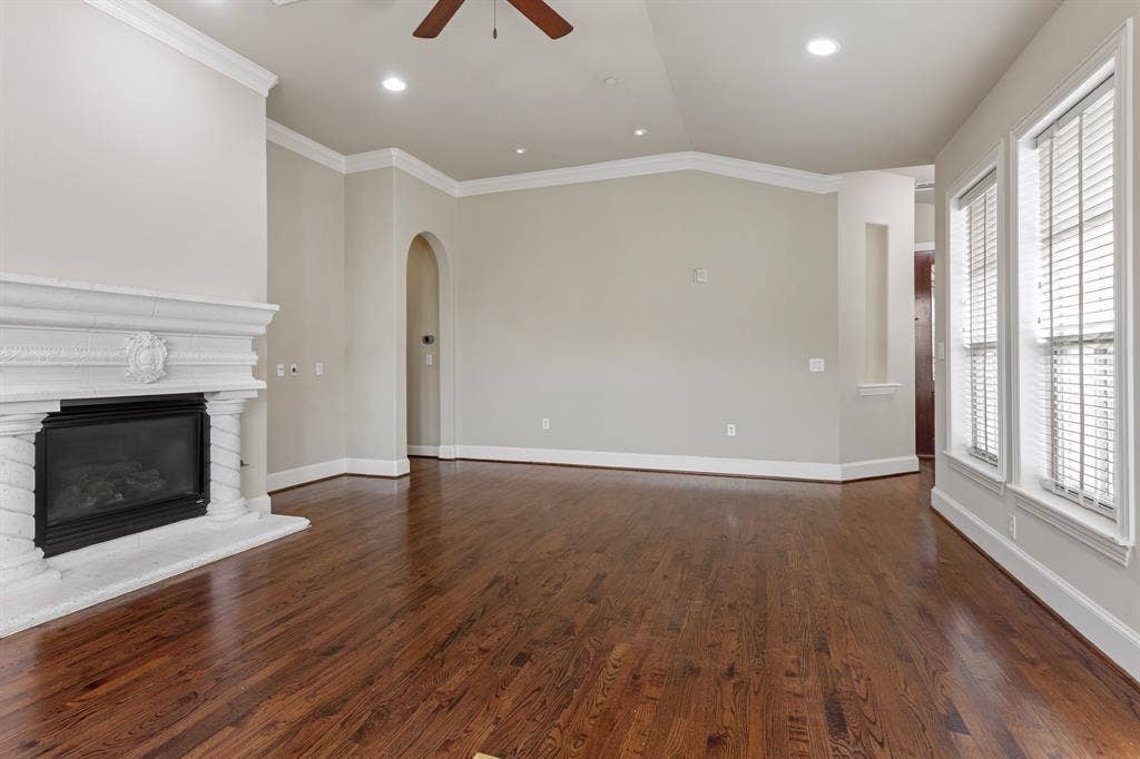Living area with gas fireplace and ceiling fan