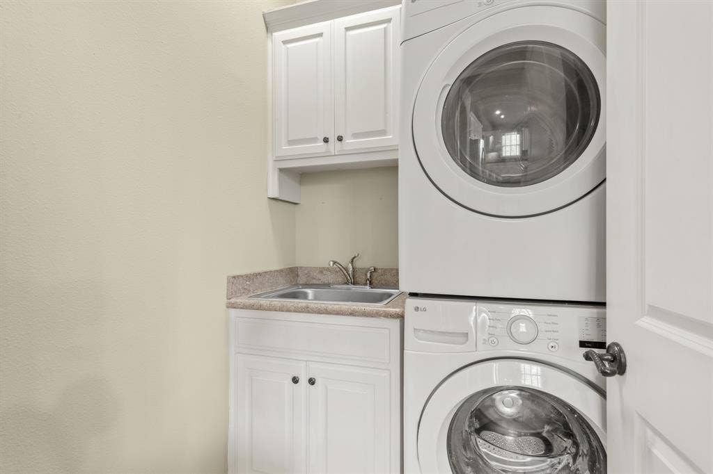 Laundry room including stacked washer and dryer