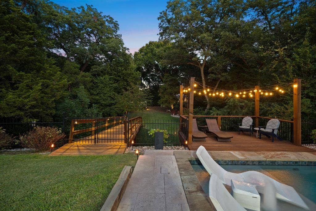 3202 Harbor Pointe Drive, Rowlett, TX 75088 Deck next to the pool with seating area view of bridge to back of property