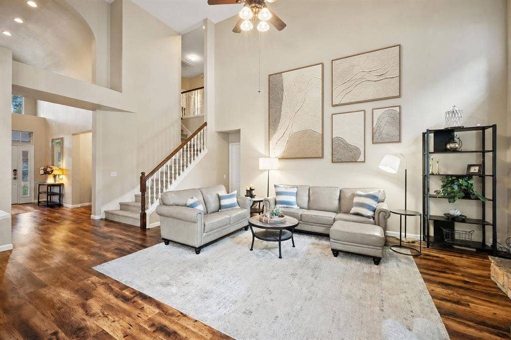 3202 Harbor Pointe Drive, Rowlett, TX 75088 Vaulted ceiling, wood-finish flooring, staircase with wood handrail and white balusters, recessed lighting, and a ceiling fan