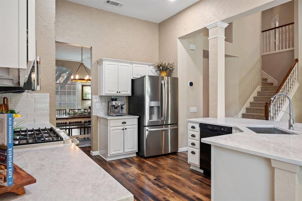 3202 Harbor Pointe Drive, Rowlett, TX 75088 Kitchen with white cabinetry, quartz countertops, and gorgeous flooring