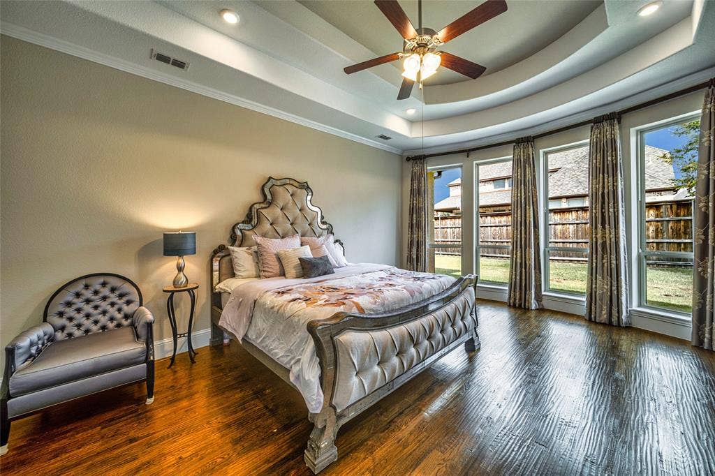 13018 Seattle Slew Street, Frisco, TX 75035 Tray ceiling with recessed lighting, wood-finish flooring, ceiling fan, and a curved wall of multiple windows