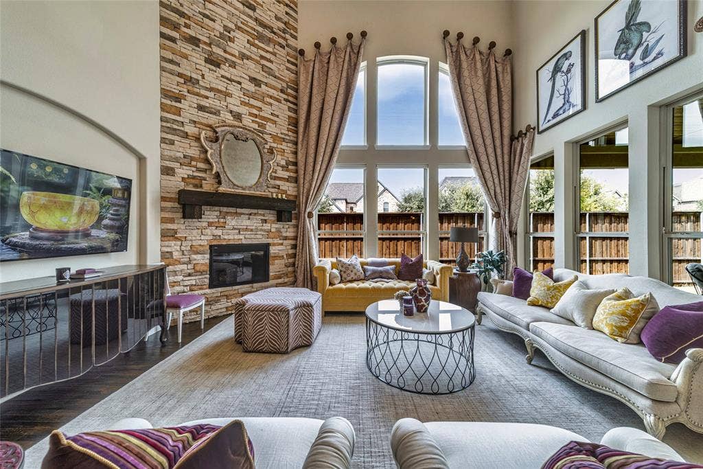 13018 Seattle Slew Street, Frisco, TX 75035 Soaring ceiling with a stacked stone fireplace and dark wood-finish mantel
