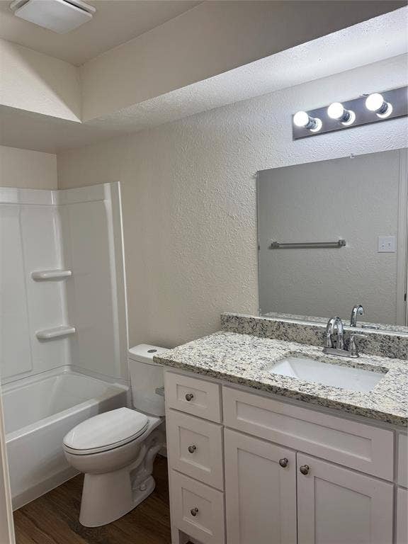 1104-1106 Mulkey Lane, Denton, TX 76209 Bathroom featuring a white vanity with cabinetry and drawers, an undermount sink, and a speckled countertop