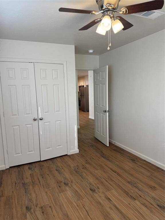 1104-1106 Mulkey Lane, Denton, TX 76209 Wood-finish flooring throughout, bright white walls, and a ceiling fan with integrated lighting