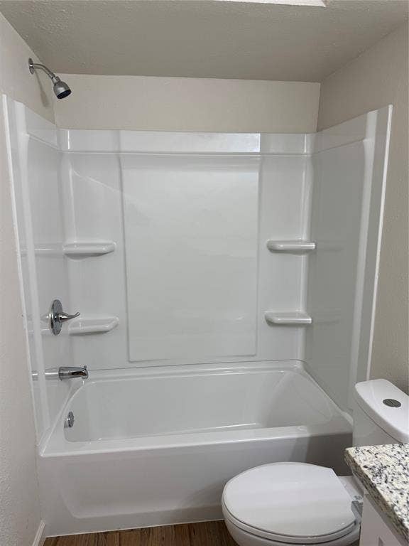 1104-1106 Mulkey Lane, Denton, TX 76209 White bathtub with shower head, built-in soap dishes, and wood-finish flooring