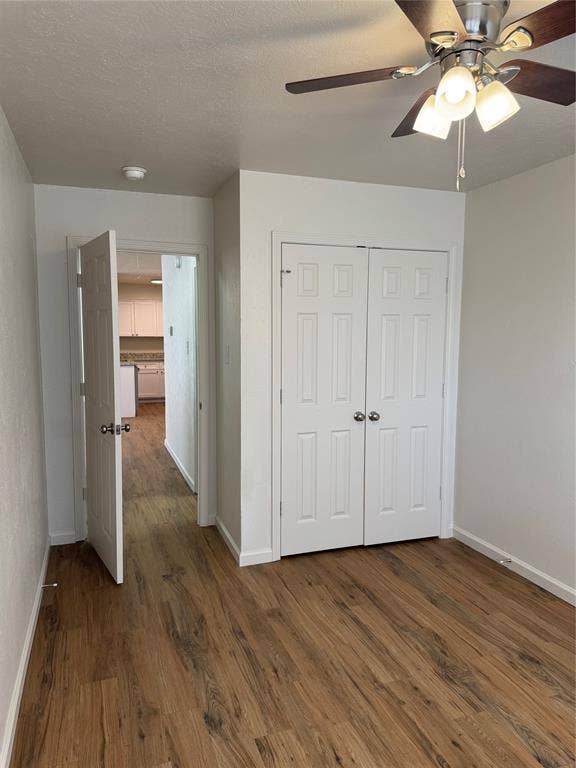 1104-1106 Mulkey Lane, Denton, TX 76209 Wood-finish flooring throughout, white paneled doors, and a ceiling fan with integrated lighting