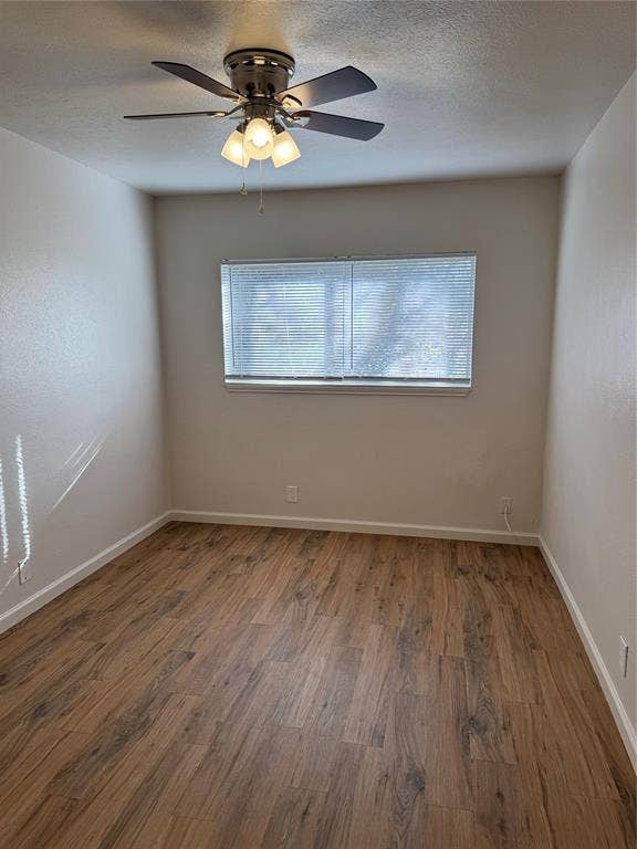 1104-1106 Mulkey Lane, Denton, TX 76209 Wood-finish flooring with white baseboards, a ceiling fan with integrated lighting, and a window with blinds