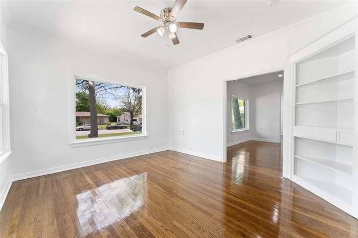 2405 Monroe Street, Commerce, TX 75428 Hardwood flooring, recessed doorway, ceiling fan, white built-in shelving, white trim