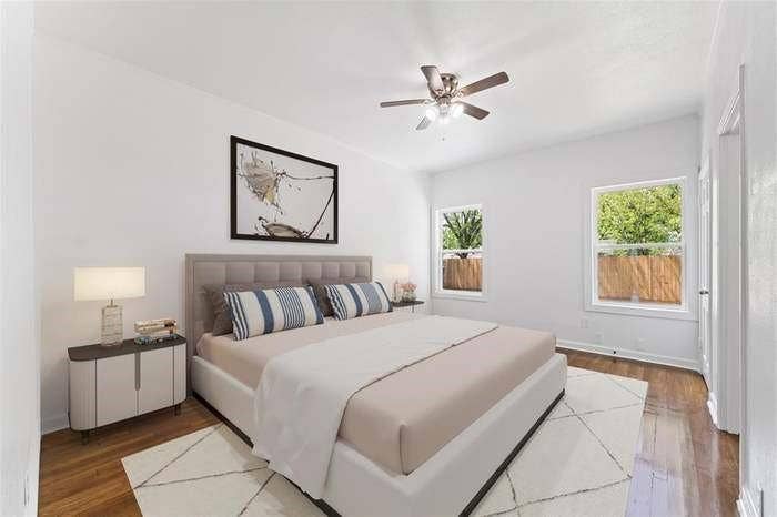 2405 Monroe Street, Commerce, TX 75428 Wood-finish flooring, white walls, two windows, and a ceiling fan with light fixture