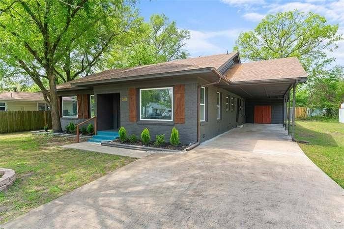 2405 Monroe Street, Commerce, TX 75428 Brick-clad exterior with wood shutters, covered carport, and paved driveway