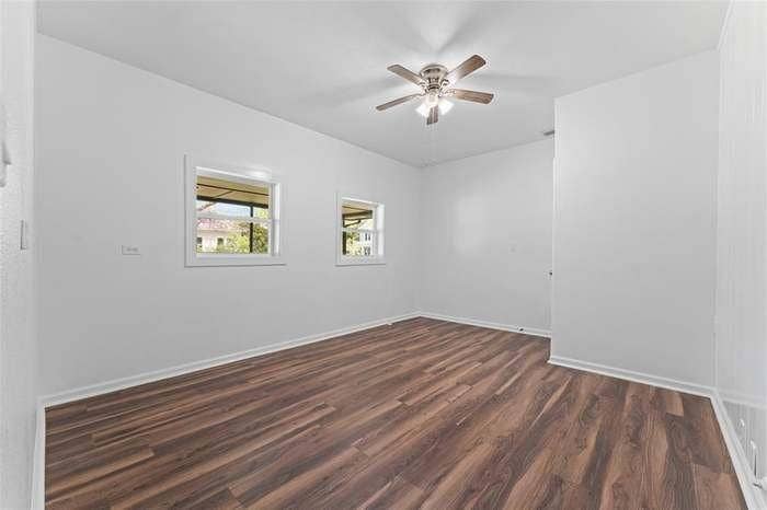 2405 Monroe Street, Commerce, TX 75428 Wood-finish flooring with white baseboards