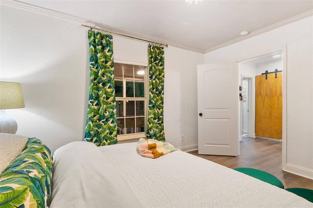214 Short Street, McKinney, TX 75069 White walls with crown molding, wood-finish flooring, and a white two-panel door