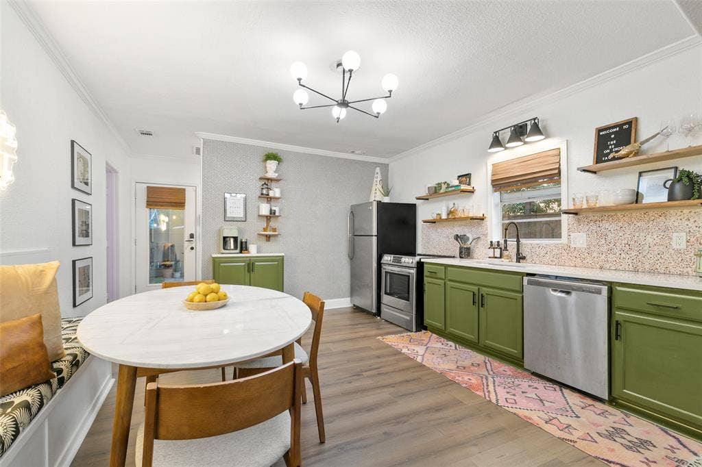 214 Short Street, McKinney, TX 75069 Kitchen area featuring wood-finish flooring, green cabinetry, stainless steel appliances, and a white countertop