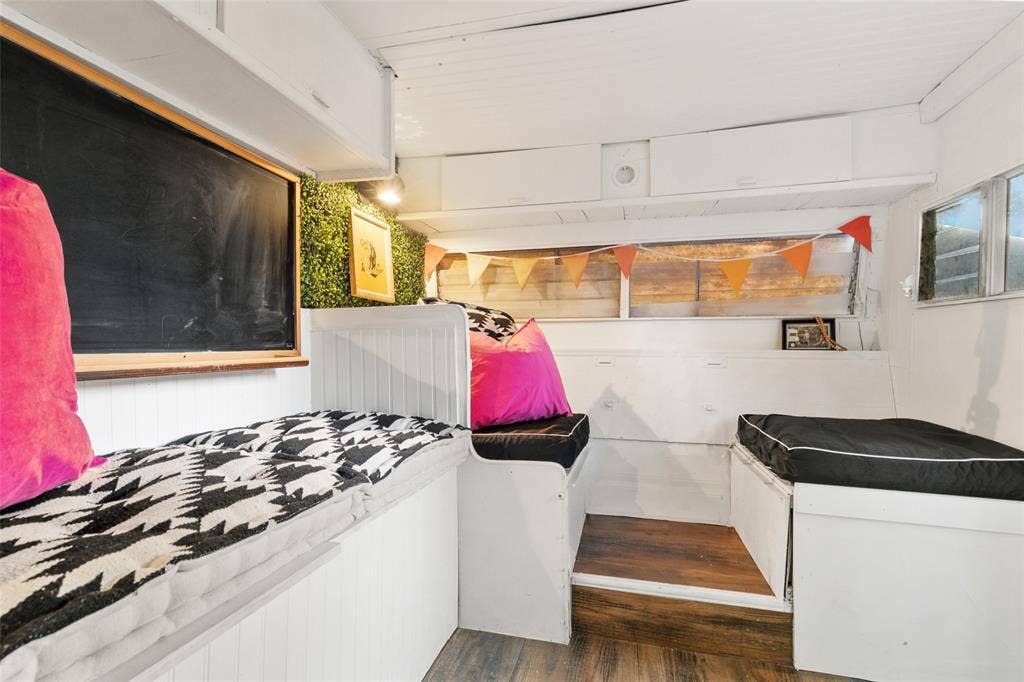 214 Short Street, McKinney, TX 75069 Built-in seating with storage, wood-finish flooring, overhead cabinetry, and a chalkboard feature