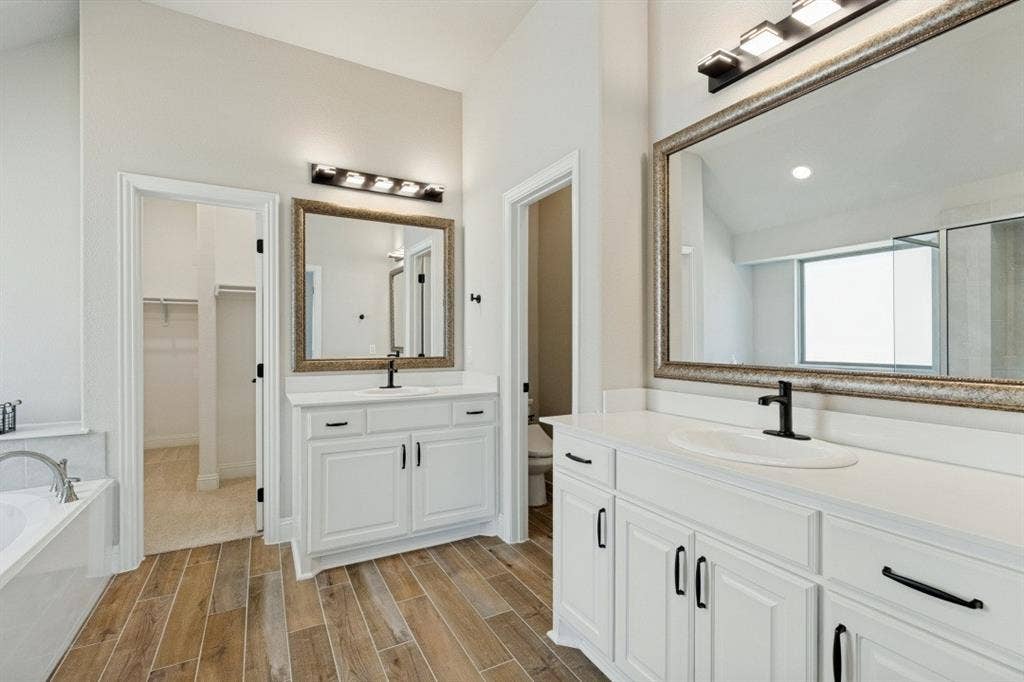 - Oversized primary bathroom  Deluxe mirror and lighting package Separate shower The porcelain, ceramic, and wood plank tile throughout most of the home!