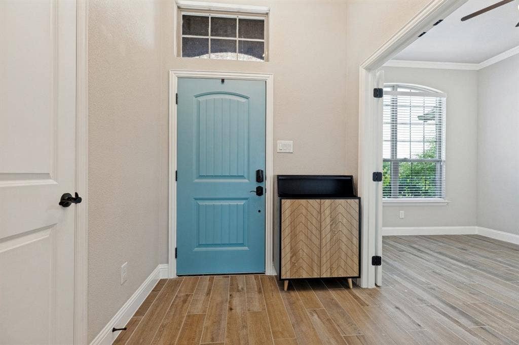 Oversize study to the right here as soon as you walk in, with a ceiling fan and windows throughout the main part of the home. You have the porcelain ceramic wood plank tiles, almost indestructible with kids and pets