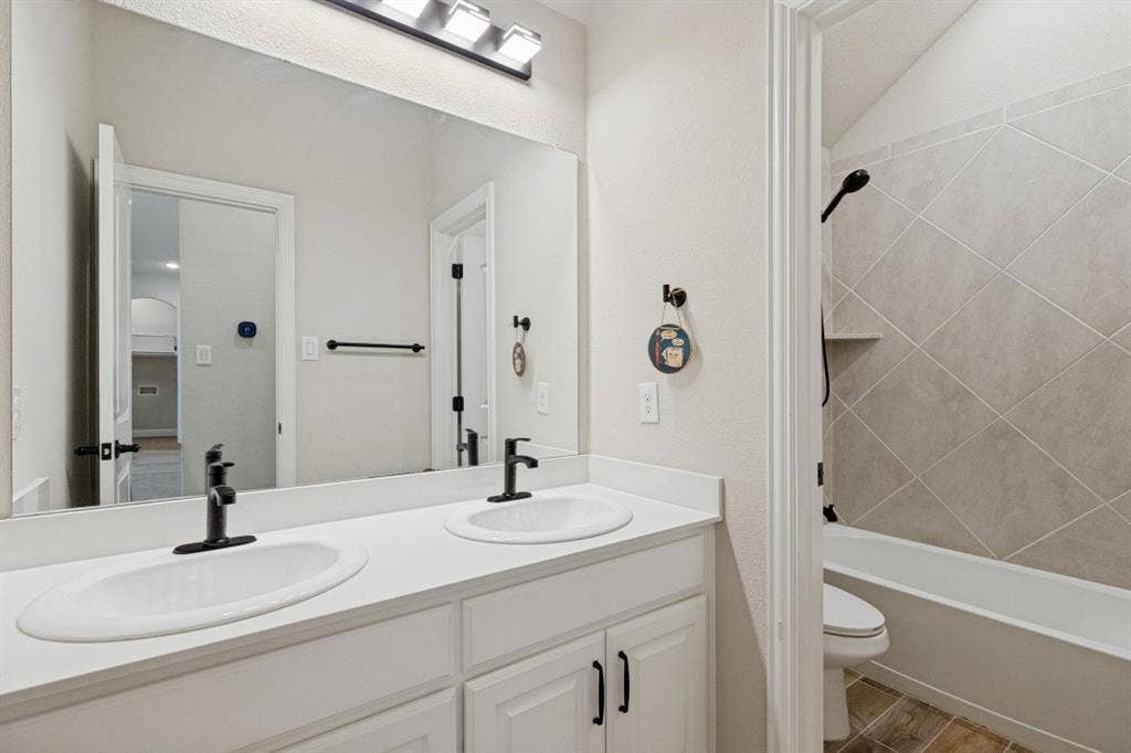 Dual vanity with white cabinetry and matte black faucets