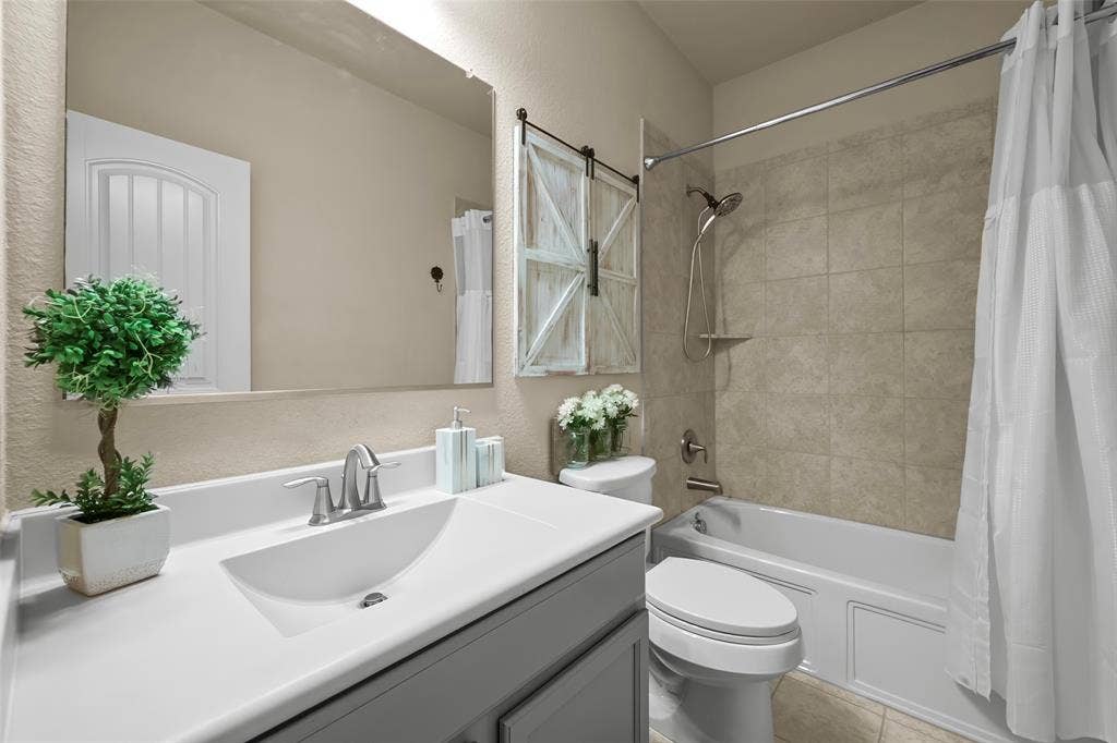 Vanity with integrated sink, brushed nickel faucet, and frameless mirror