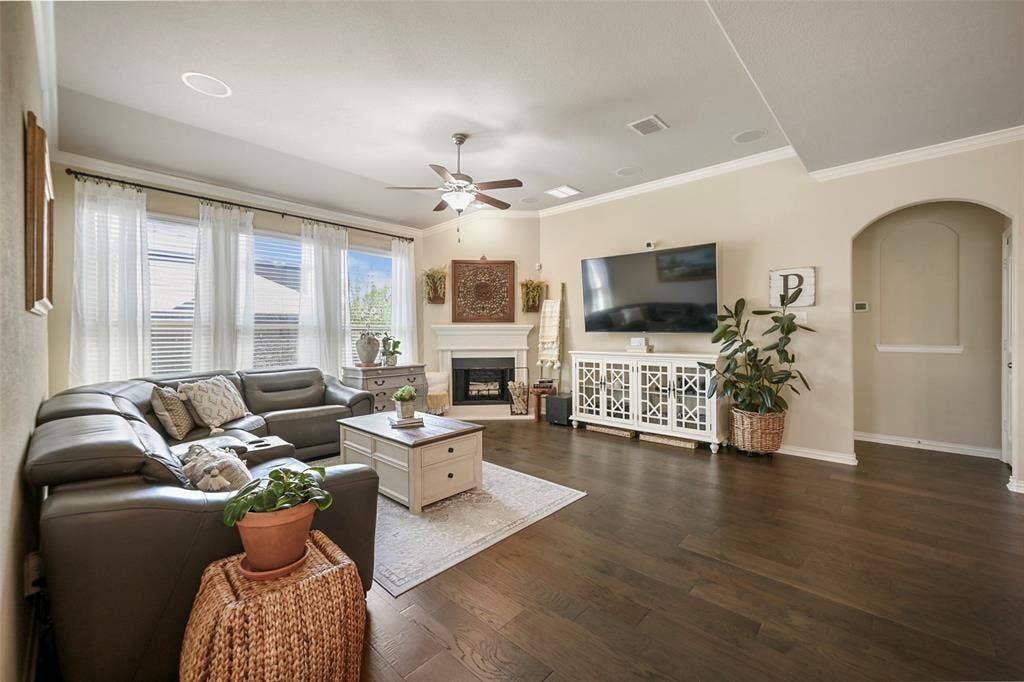 Wood-finish flooring, recessed lighting, and a ceiling fan with light fixture