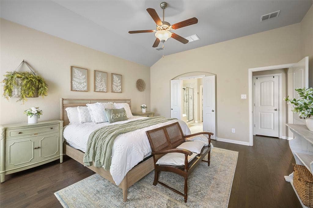 Vaulted ceiling with a ceiling fan, dark wood-finish flooring, and white paneled doors
