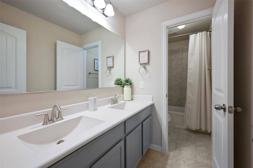 Dual vanity with integrated sinks, brushed nickel faucets, and under-cabinet storage