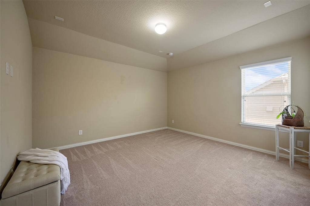 Neutral-toned walls complement the carpeted flooring