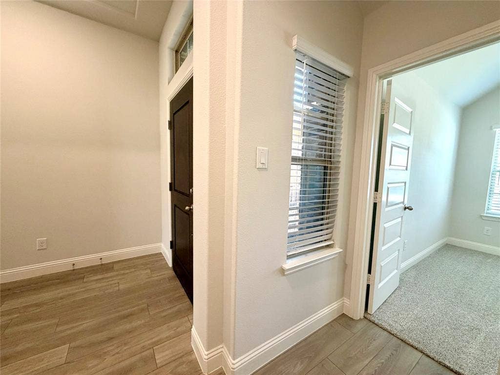 3806 Chicory Court, Melissa, TX 75454 Bright, natural light floods the entryway and front hallway, which features a charming transom window above the front door and an additional window looking out toward the entry porch. This bright, inviting hallway leads directly into a convenient front bedroom.