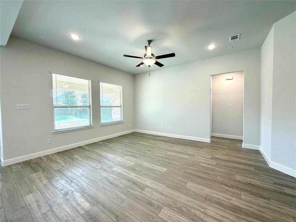 3806 Chicory Court, Melissa, TX 75454 This spacious living area features impressive high ceilings that create an open, airy atmosphere. View looking at hallway to the primary bedroom suite.