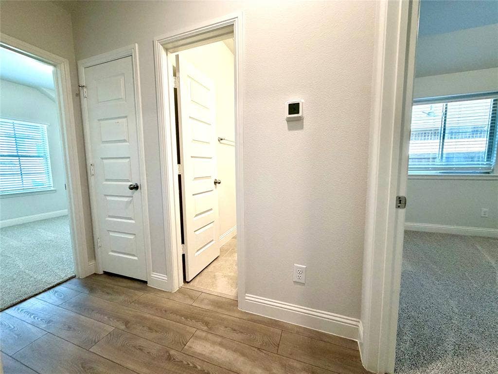 3806 Chicory Court, Melissa, TX 75454 This spacious and well-lit hallway is conveniently located just off the main entry, providing seamless and easy access to two comfortable secondary bedrooms as well as a full, well-appointed shared bathroom.