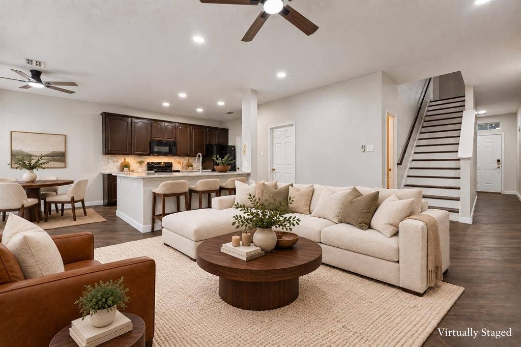 4215 Maidstone Drive, Garland, TX 75043 Wood-finish flooring throughout, dark wood cabinetry, white countertops, and a staircase with dark treads and white risers