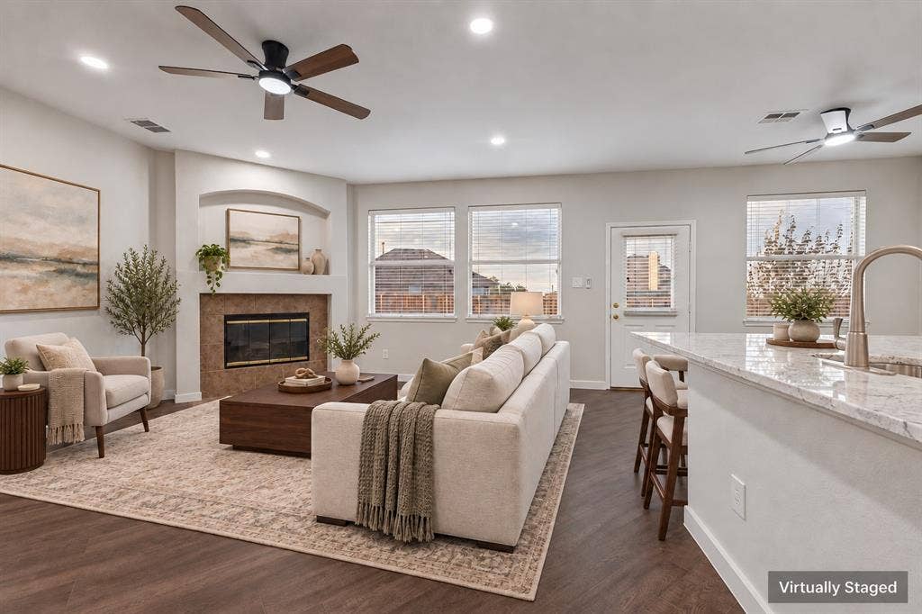 4215 Maidstone Drive, Garland, TX 75043 Living area with wood-finish flooring, a fireplace featuring a tiled surround, recessed lighting, and ceiling fans