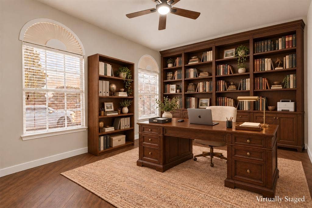 4215 Maidstone Drive, Garland, TX 75043 Built-in wood-finish shelving, wood-finish flooring, ceiling fan with integrated lighting, and multiple arched windows with blinds