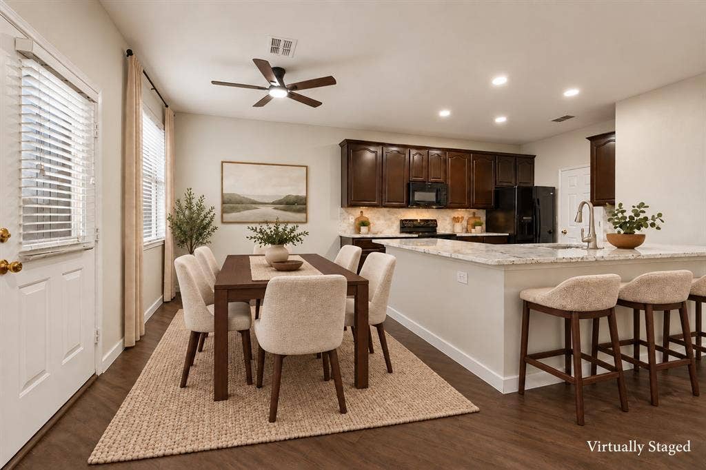 4215 Maidstone Drive, Garland, TX 75043 Open-concept living space featuring wood-finish flooring, recessed lighting, a ceiling fan, dark wood cabinetry, and light-toned countertops