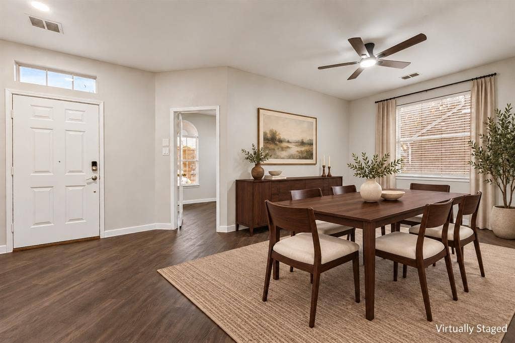 4215 Maidstone Drive, Garland, TX 75043 Wood-finish flooring, white paneled door with transom window, ceiling fan with integrated lighting, and multiple windows with blinds