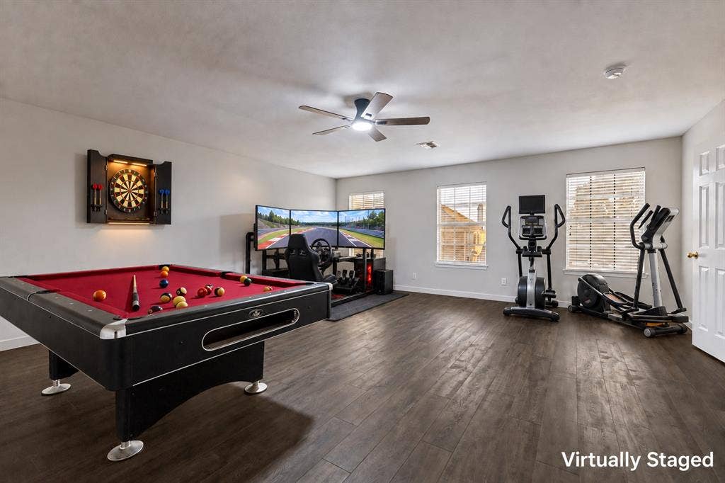 4215 Maidstone Drive, Garland, TX 75043 Spacious room featuring a pool table, wood-finish flooring, three windows with blinds, and a ceiling fan with integrated lighting