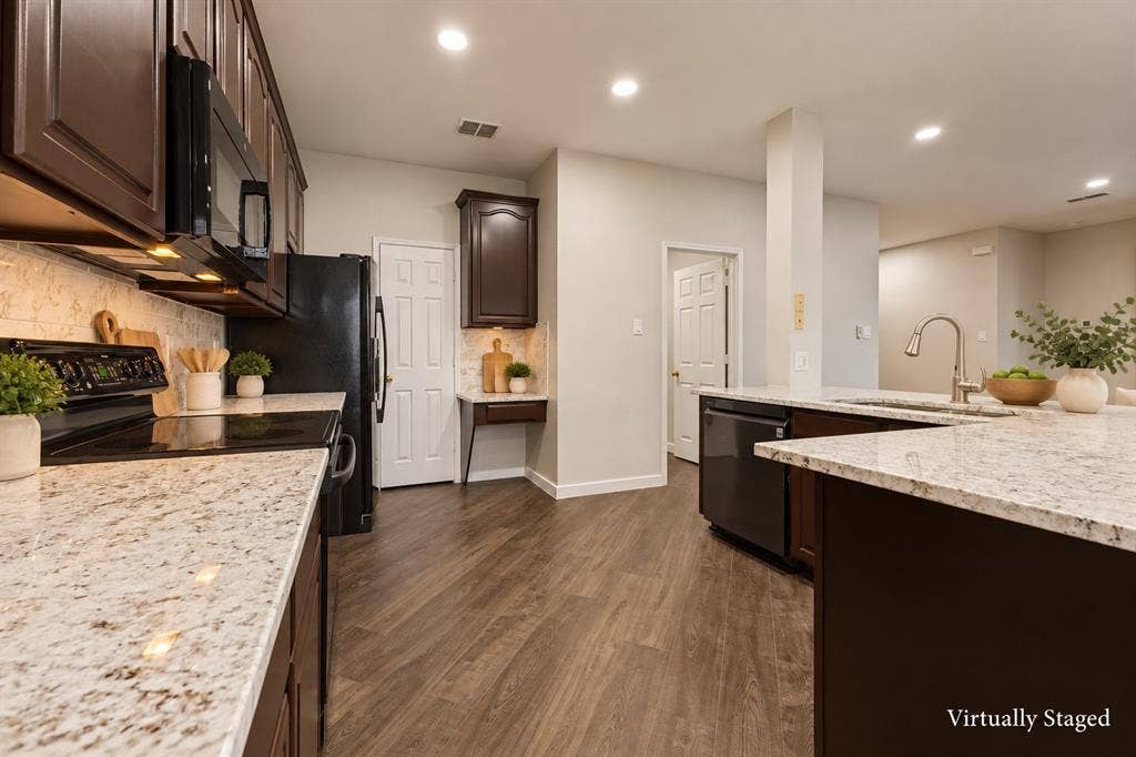4215 Maidstone Drive, Garland, TX 75043 Kitchen featuring dark wood-finish cabinetry, light-toned countertops, a built-in microwave, an integrated dishwasher, and wood-finish flooring